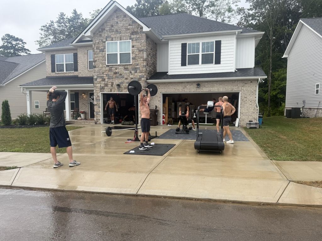 Overhead press in the rain-soaked driveway
